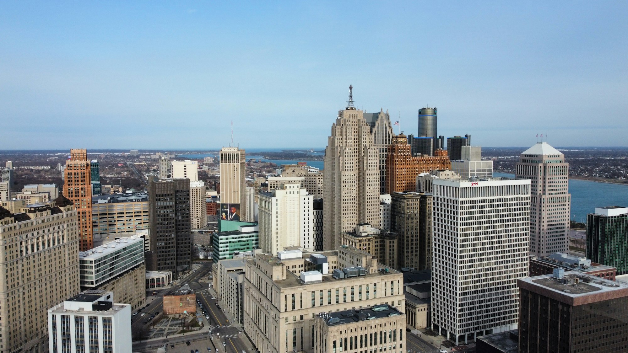 Downtown Detroit buildings with the river and Belle Isle in the distance