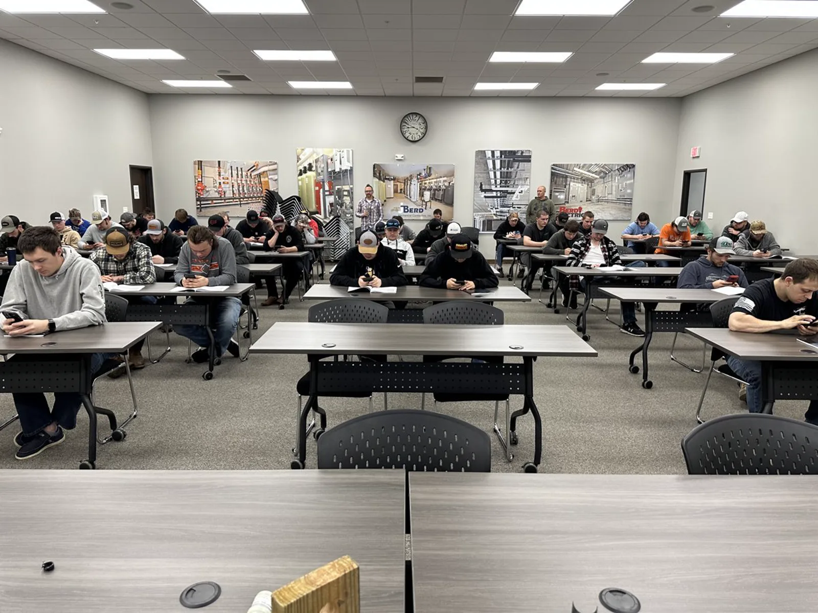 Contractors seated at tables in a classroom product session at a contractor’s training facility